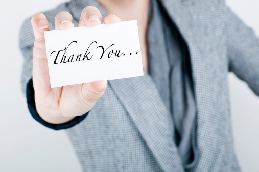 Man holding a thank you card