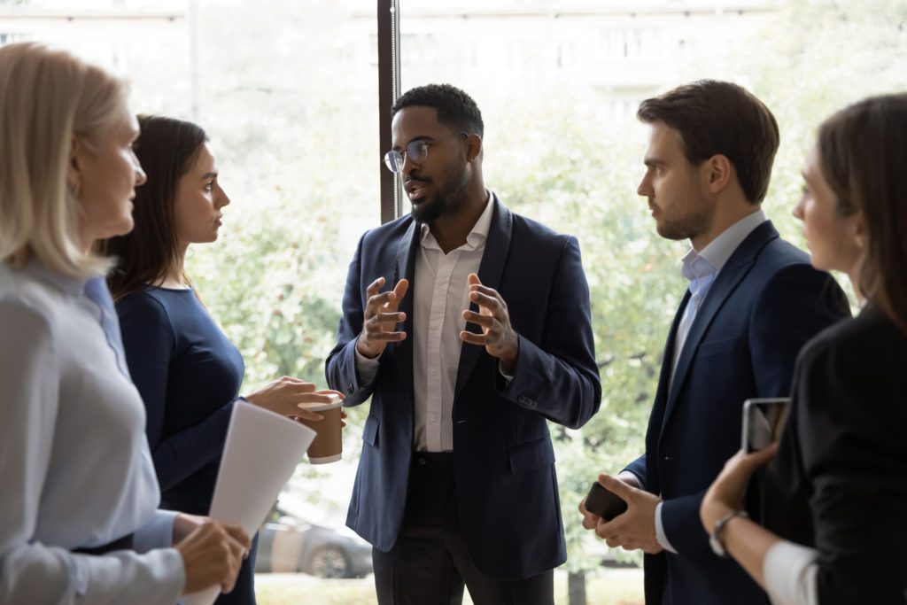 professional man speaking to a group of other professionals