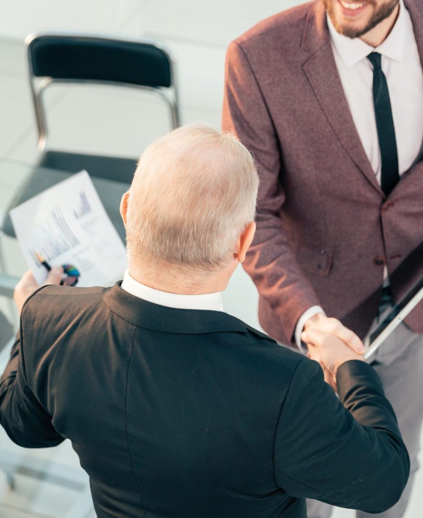 top view. business colleagues shaking hands with each other