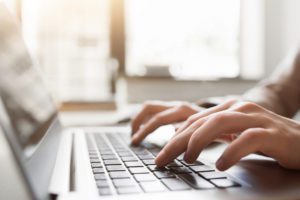 Typing on laptop closeup